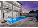 Beautiful pool and spa area with lounge chairs and balconies on a multi-story home at 110 Carlyle Dr, Palm Harbor, FL 34683