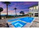 Stunning pool and spa with lounge chairs, palm trees, and ocean views at sunset at 110 Carlyle Dr, Palm Harbor, FL 34683