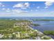 High aerial view showing the waterfront neighborhood surrounded by lush islands and sparkling ocean waters at 1110 Canal St, Ruskin, FL 33570