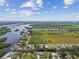 Aerial view of the property near winding waterways, lush greenery, and the neighborhood at 1110 Canal St, Ruskin, FL 33570