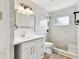 Modern bathroom showcasing new gray tile, updated fixtures, and an inviting walk-in shower at 1110 Canal St, Ruskin, FL 33570