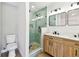 Beautiful bathroom featuring glass door walk-in shower with unique tiling and double sink vanity at 1110 Canal St, Ruskin, FL 33570