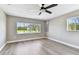 Bright bedroom with wood-look floors, neutral walls and two windows for beautiful exterior views at 1110 Canal St, Ruskin, FL 33570