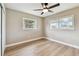 A light-filled bedroom with new flooring, ceiling fan, and views from large windows at 1110 Canal St, Ruskin, FL 33570