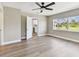 Bedroom with neutral walls and wood-look floors open to the bright white kitchen at 1110 Canal St, Ruskin, FL 33570