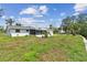 Rear exterior of the home showing a screened porch and spacious yard perfect for outdoor activities and relaxation at 1110 Canal St, Ruskin, FL 33570