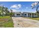 Charming single-story home with a long driveway and mature trees in a serene neighborhood at 1110 Canal St, Ruskin, FL 33570