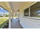 Spacious front porch with tiled flooring and stylish pillars, perfect for enjoying the outdoors at 1110 Canal St, Ruskin, FL 33570