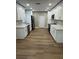Modern kitchen with shaker cabinets, stainless steel appliances and durable wood-look floors at 1110 Canal St, Ruskin, FL 33570