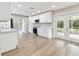 Open concept kitchen boasts stainless steel appliances, white cabinets, lots of counter space and natural light at 1110 Canal St, Ruskin, FL 33570