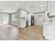 Bright, airy kitchen features stainless appliances, white cabinets, and new floors in an open floor plan at 1110 Canal St, Ruskin, FL 33570
