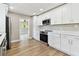 Stylish kitchen with stainless appliances, white cabinets, quartz countertops and a modern, streamlined aesthetic at 1110 Canal St, Ruskin, FL 33570