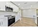 Updated kitchen featuring modern stainless steel appliances, white cabinets, and sleek countertops at 1110 Canal St, Ruskin, FL 33570