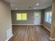 Bright living room features wood flooring, neutral walls, and natural light from windows at 1110 Canal St, Ruskin, FL 33570
