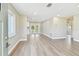 Bright, open-concept living room with modern flooring and French doors leading to the outdoors at 1110 Canal St, Ruskin, FL 33570