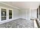 Enclosed patio with tiled floor and double doors at 1110 Canal St, Ruskin, FL 33570