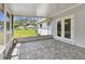 Enclosed patio with tiled floor and access to the yard via glass doors at 1110 Canal St, Ruskin, FL 33570