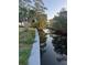 Scenic waterfront view featuring lush greenery reflecting in the tranquil canal, perfect for nature enthusiasts at 1110 Canal St, Ruskin, FL 33570