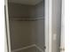 A basic, walk-in closet with a shelf and neutral paint, ready for customization and organization at 116 Cranbrooke Dr, Seffner, FL 33584