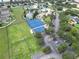 This aerial view showcases the community's blue tennis/basketball courts, pond, and pool area at 11728 Crest Creek Dr, Riverview, FL 33569