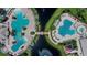 Aerial view features community amenities including dual pools and a bridged waterway at 11728 Crest Creek Dr, Riverview, FL 33569