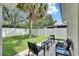 Backyard patio featuring outdoor furniture and a view of the lush, green lawn and landscaping at 11728 Crest Creek Dr, Riverview, FL 33569