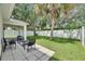 Backyard patio with seating area with lush green lawn, and a white fence in the background at 11728 Crest Creek Dr, Riverview, FL 33569