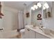 Well-lit bathroom with shower-tub combo and decorative wall accents at 11728 Crest Creek Dr, Riverview, FL 33569