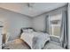 Cozy bedroom featuring neutral tones, ceiling fan, and natural light from the window at 11728 Crest Creek Dr, Riverview, FL 33569
