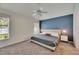 This bedroom has a large bed with end tables and windows for natural light at 11728 Crest Creek Dr, Riverview, FL 33569