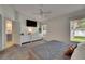 Bedroom featuring a large bed, dresser, and windows, with view into kitchen at 11728 Crest Creek Dr, Riverview, FL 33569