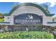 Elegant Rivercrest community sign featuring a heron and lush landscaping at 11728 Crest Creek Dr, Riverview, FL 33569