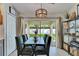 Dining area showcasing sliding glass doors to the backyard and modern light fixture at 11728 Crest Creek Dr, Riverview, FL 33569