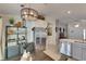 Open dining area with modern light fixture, stainless fridge, and decorative shelving at 11728 Crest Creek Dr, Riverview, FL 33569