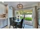 Dining area featuring a stylish light fixture and sliding glass doors to patio at 11728 Crest Creek Dr, Riverview, FL 33569