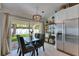 Dining area featuring modern light fixture and sliding glass doors to outdoor space at 11728 Crest Creek Dr, Riverview, FL 33569