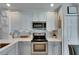 Modern kitchen featuring white cabinetry, stainless steel appliances, and stylish backsplash at 11728 Crest Creek Dr, Riverview, FL 33569