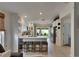 Open kitchen with white cabinetry, island with seating, and stainless steel appliances at 11728 Crest Creek Dr, Riverview, FL 33569