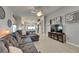 Comfortable living room with gray sectional sofa, light wood floors, and stylish wall decor at 11728 Crest Creek Dr, Riverview, FL 33569