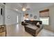 Bright living room with large sectional sofa, white walls, and light wood-look flooring at 11728 Crest Creek Dr, Riverview, FL 33569