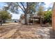 Exterior backyard view featuring pergola, mature tree and gravel ground cover at 131 44Th N Ave, St Petersburg, FL 33703