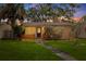 Charming single-story home featuring a stone pathway, manicured lawn, and inviting front porch at 131 44Th N Ave, St Petersburg, FL 33703