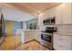 Modern kitchen featuring stainless steel appliances, granite countertops and white cabinetry at 131 44Th N Ave, St Petersburg, FL 33703