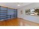 Bright living room with hardwood floors, shelving, a ceiling fan, and lots of natural light at 131 44Th N Ave, St Petersburg, FL 33703