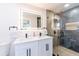 Well-lit bathroom features a double vanity, quartz countertops, and a glass-enclosed shower at 14261 113Th Ave, Largo, FL 33774