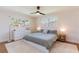 Bright bedroom featuring a queen-sized bed, ceiling fan, hardwood floors, and plenty of natural light at 14261 113Th Ave, Largo, FL 33774