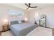 Bedroom showcasing a comfortable queen-sized bed, contemporary ceiling fan, and en-suite bathroom at 14261 113Th Ave, Largo, FL 33774