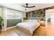 Stylish bedroom boasts hardwood floors, a modern accent wall, and a ceiling fan for added comfort at 14261 113Th Ave, Largo, FL 33774
