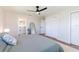 Bright bedroom with a bed, bathroom access, a large closet, ceiling fan, and hardwood floors at 14261 113Th Ave, Largo, FL 33774