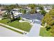 Charming single-story home featuring a well-manicured lawn, mature trees, and gray tones at 14261 113Th Ave, Largo, FL 33774